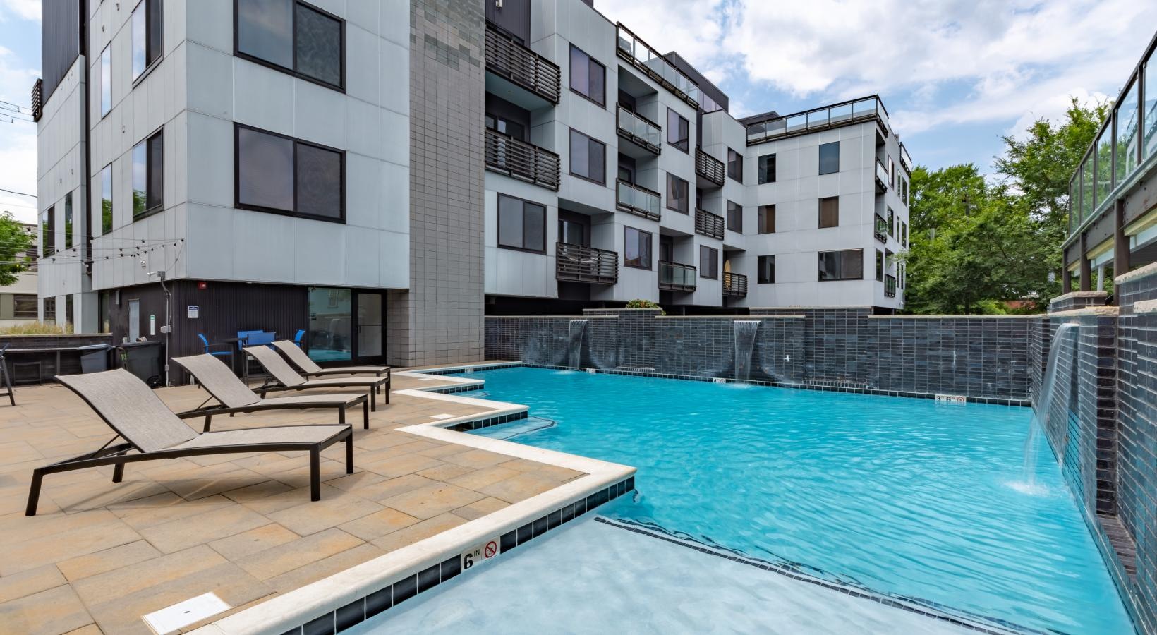 Resort-style swimming pool a pool with a building in the background
