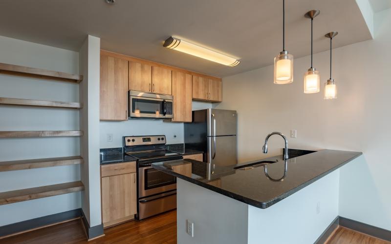 a kitchen with a stainless steel stove and a stainless steel refrigerator