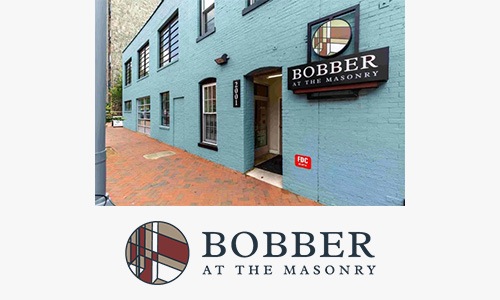 Bobber a logo and a blue building