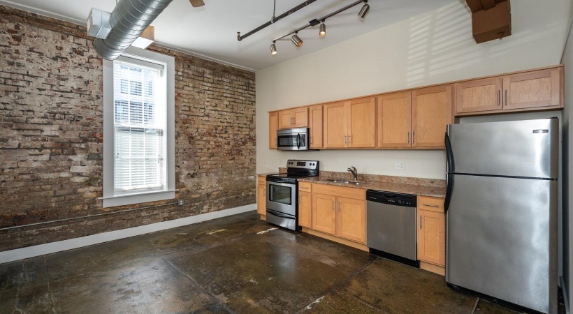 a kitchen with a brick wall