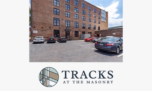 Tracks a logo and a parking lot and multi-level building